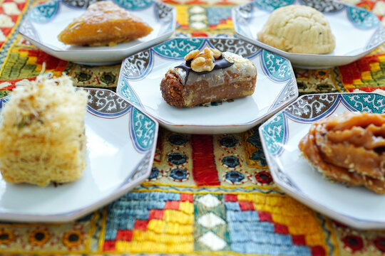 Assorted Middle Eastern pastries and baklava on traditional patterned plates