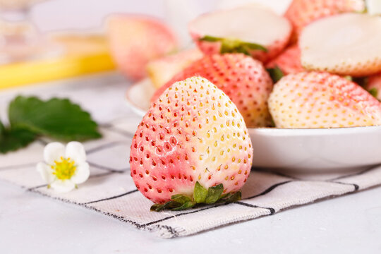 Fresh White Pink Gradient Strawberries Dandong Variety on Light Background with Bowl Display