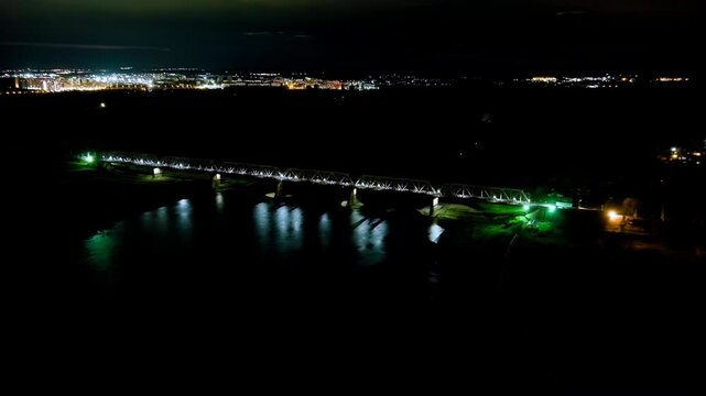 Ufa, Russia. Railway bridge across the Belaya River. Night city lights. Drone footage
