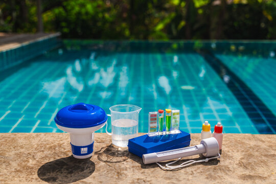 Pool water testing kit on pool edge showing pH and chlorine levels with chemical dosing tools for swimming pool maintenance