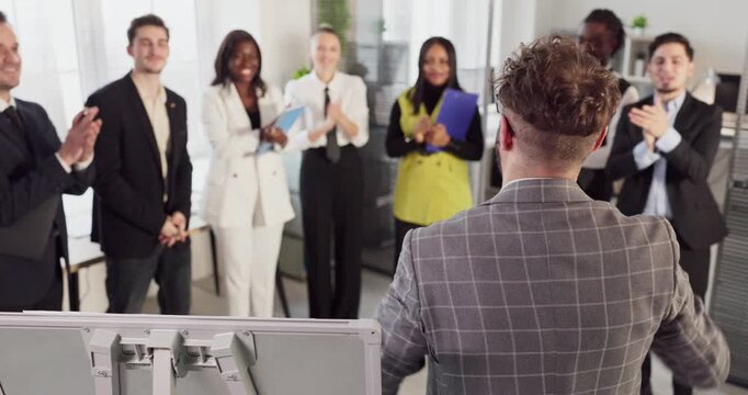 Team businesspeople leader applause meeting success training strategy. A diverse group claps after a strategy presentation near a whiteboard. Leadership and teamwork recognition in office.