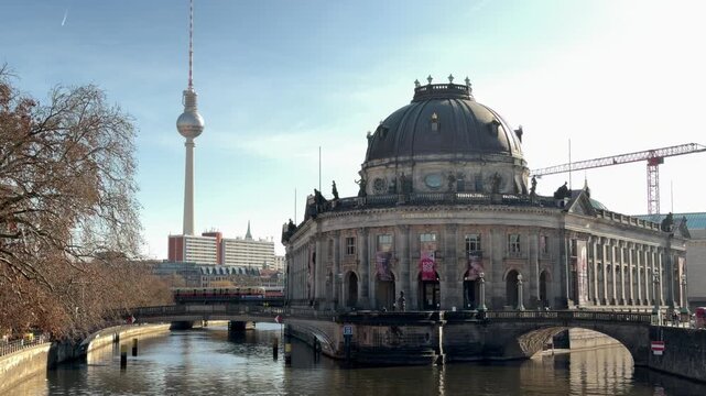 Bode Museum in Berlin with Fernsehturm, sunny winter day, tranquil river