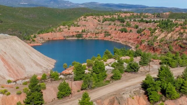 Turquoise mineral lagoon inside quarry aerial drone Greece landscape