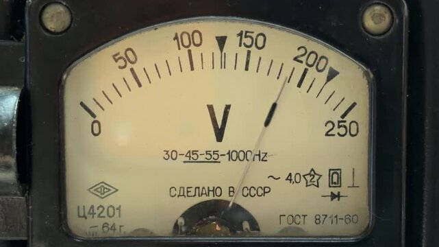 An analog voltmeter needle fluctuates as electricity flows through the internal coils. This electrical regulation produces a steady, low-frequency hum and a faint mechanical vibration.