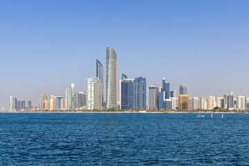 Fototapeta premium Abu Dhabi skyline with skyscrapers at sea in Abu Dhabi, United Arab Emirates