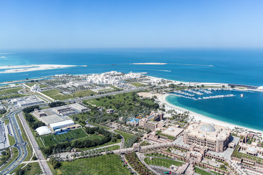Abu Dhabi skyline from above with UAE Presidential Palace and Emirates Palace in Abu Dhabi, United Arab Emirates