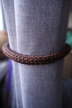 Canvas curtain with a pick-up cord. Vertical fabric background.