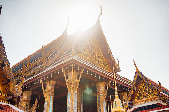 Golden temple roof with sun flare at Grand Palace Bangkok Thailand