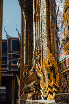 Ornate temple wall detail with gold and mosaic at Grand Palace Bangkok