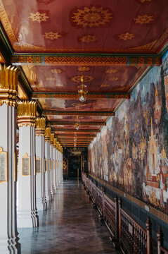 Ornate temple corridor with mural paintings at Grand Palace Bangkok