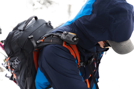 Close up of a skier adjusting equipment