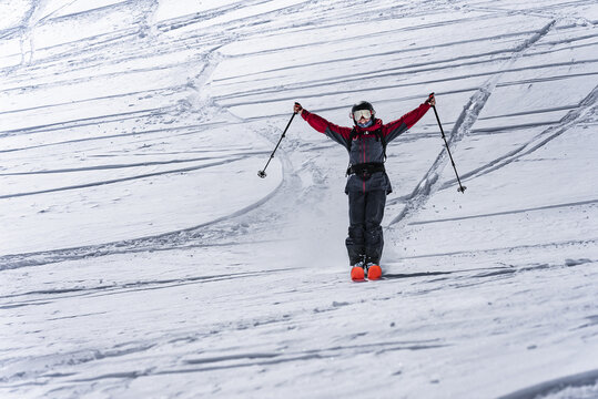 Skier with arms outstretched enjoying the ride