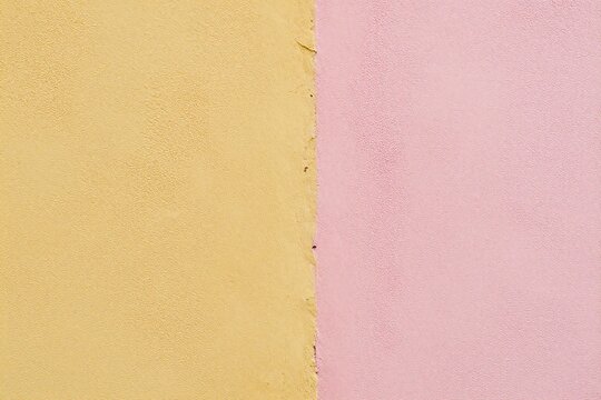 a yellow and pink wall with a yellow frame