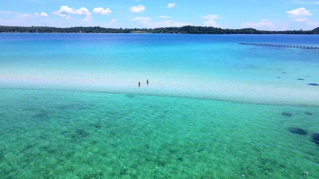 Discover the beauty of Koh Kham, Thailand, with its crystal-clear waters and sandy shores. Travelers enjoy a serene day among the picturesque landscapes and vibrant sea life.