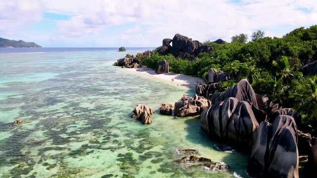 Witness stunning rock formations and turquoise waters at Anse Source d'Argent, a paradise on La Digue Island in Seychelles, where nature's artistry meets tranquil beaches.