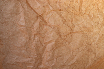 Fototapeta premium Wrinkled brown baking paper, crumpled surface, abstract textured wallpaper