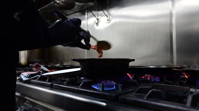 Professional chef cooking traditional spanish paella with lobster