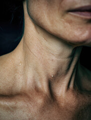 Naklejka premium Postpartum depression mother crying shown through close up of woman neck and jawline with visible skin texture and subtle emotional expression