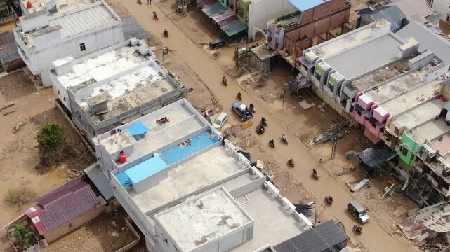 Top down drone shot showing rescue vehicle driving on road after flash flood in Aceh Tamiang Indonesia filmed December 2025 capturing aftermath of November 2025 disaster