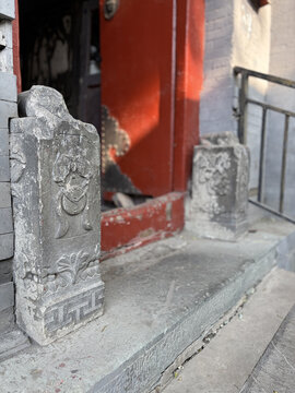 Traditional Stone Lions in Beijing Hutongs with Red Door and Historic Architecture