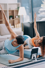 Fototapeta premium Support, teamwork and fitness couple doing workout training, challenging exercise for endurance, strength and stamina in a gym. Active, fit man and woman giving support and motivation during pushup