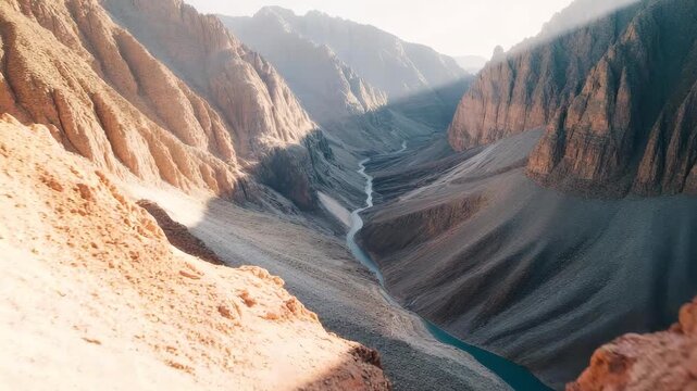 Dramatic canyon landscape with rugged mountain walls and deep valley in desert environment