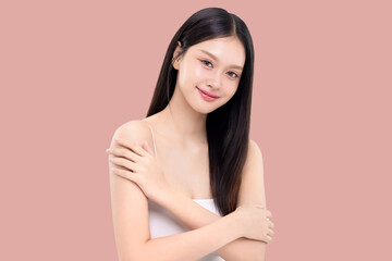 Beautiful young Asian woman with long straight hair and healthy smooth skin isolated on pink...