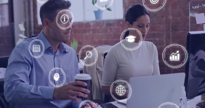 Man offering coffee cup, woman pausing laptop work and discussing tech project with floating icons