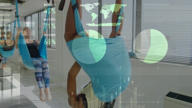 Lead woman tucking, gripping straps and inverting for fitness while HUD data overlaying motion