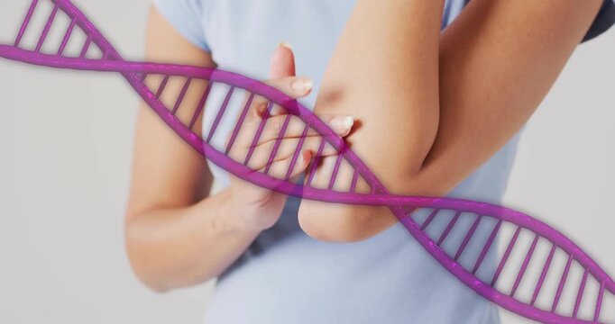 Woman touching right elbow with left hand, massaging for health purple helix overlay crossing hands