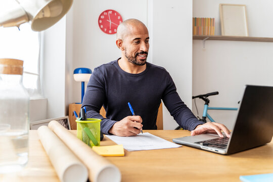Freelance professional working remotely at modern home office desk