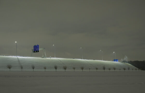 Snowy motorway with lampposts at night near Utrecht Netherlands