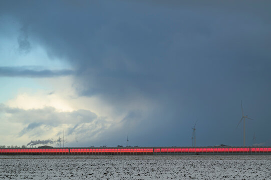 LED lit greenhouse and wind turbines in Middenmeer Netherlands landscape
