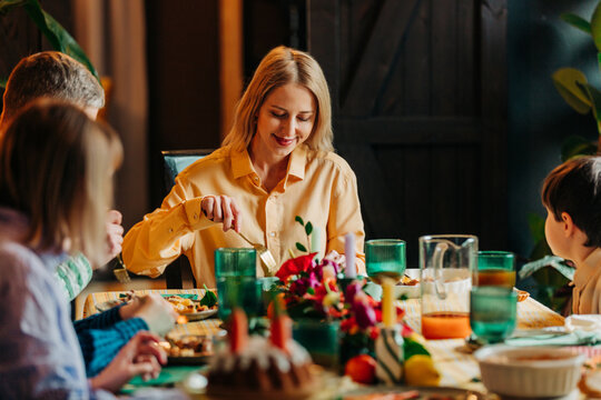 Family enjoying Easter dinner together at home with festive meal