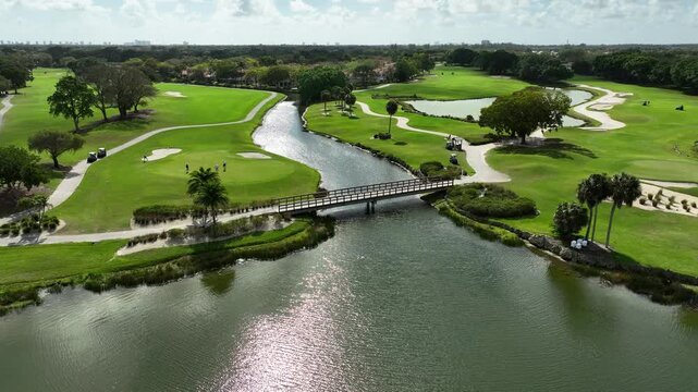 A drone view over the crossing bridge on the golf course fairways at PGA National Resort.