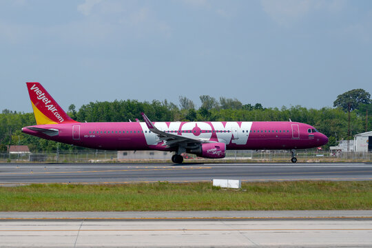 Airbus a321 Vietjet WOW airways landing above beautiful beach with people on the beach and sea, travel. Thailand, Phuket International airport. 09 March 2026.