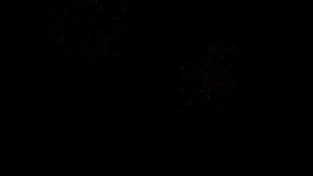 Stunning fireworks display illuminates night sky with vibrant colorful explosions creating dynamic festive atmosphere