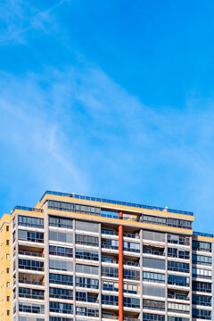 Modern urban architecture shows apartment tower in Benidorm Spain against open sky with minimal form and daylight atmosphere reflecting coastal density