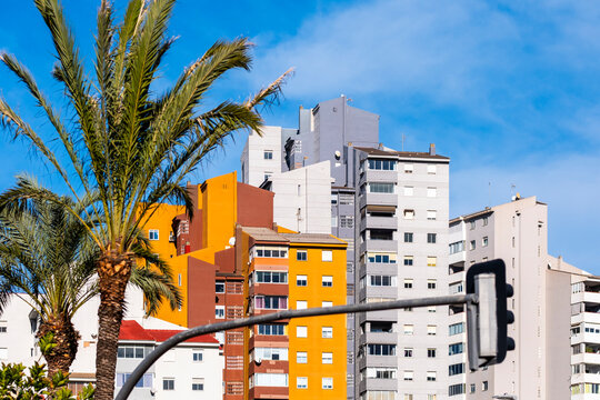 Colorful urban architecture shows apartment building in Benidorm Spain with palm street and blue sky highlighting coastal housing density