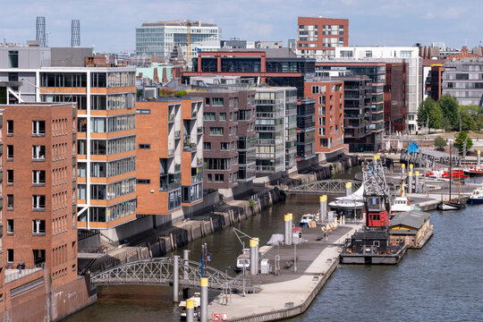 Modern marina waterfront with apartment architecture along canal in Hamburg Germany featuring urban development and harbor cityscape in daylight