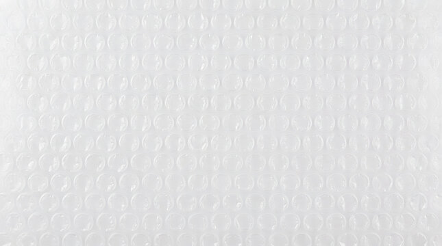 Flat texture of uniform transparent plastic bubble wrap, industrial grid packaging background.