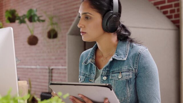 Headphones, computer and business woman with tablet for music, review or graphic design for brand. Audio, designer and creative person with tech for visual layout of logo, project or listen to radio
