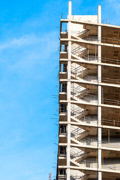 Daylight urban construction building framework with concrete scaffold floors against sky showing vertical development progress in spain with strong lines