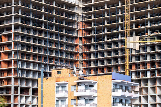 Daylight urban construction building highrise facade with crane concrete scaffold showing development progress in spain on a growing skyline