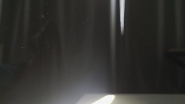 Atmospheric Sunlight Beam with Floating Dust Particles in a Dark Room.
