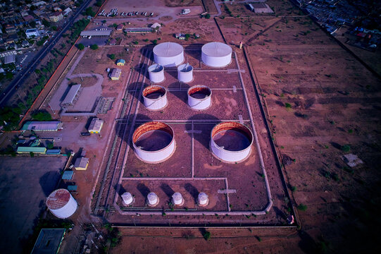 Aerial view of cylindrical tanks contrasting against the arid landscape, reflecting the harsh sunlight, Hotoro maiduguri road, Kano, Kano, Nigerian.