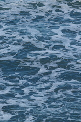 Obraz premium Deep Blue Ocean Wave Texture with Sea Foam Natural Water Background Abstract Marine Pattern Calming Sea Surface