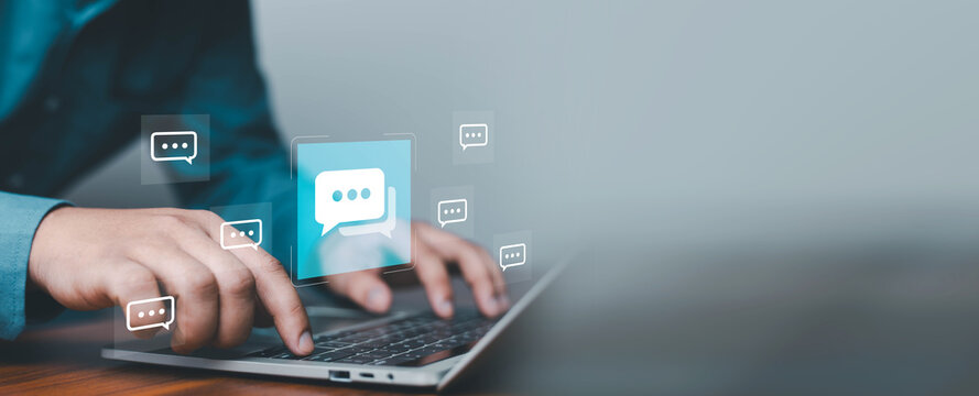 Business communication concept with hands typing on laptop and virtual chat icons, representing online messaging, customer support, digital marketing, and modern technology interaction in a connected