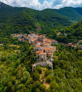 Aerial view of an ancient village nestled amongst lush green hillsides, a symphony of terracotta roofs and stone walls, Terni, Umbria, Italy.