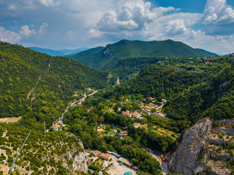 Aerial view of the verdant valley with a road winding through lush greenery near Ponte delle Marmore, Terni, Umbria, Italy.